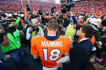 January 19, 2014; Denver, CO, USA; Denver Broncos quarterback Peyton Manning (18) following the 26-16 victory against the New England Patriots following the 2013 AFC Championship football game at Sports Authority Field at Mile High. Mandatory Credit: Mark J. Rebilas-USA TODAY Sports