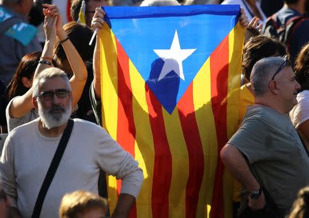 A Catalan separatist flag is held up at a demonstration organised by Catalan pro-independence movements ANC (Catalan National Assembly) and Omnium Cutural, following the imprisonment of their two leaders Jordi Sanchez and Jordi Cuixart, in Barcelona, October 21, 2017. REUTERS/Ivan Alvarado