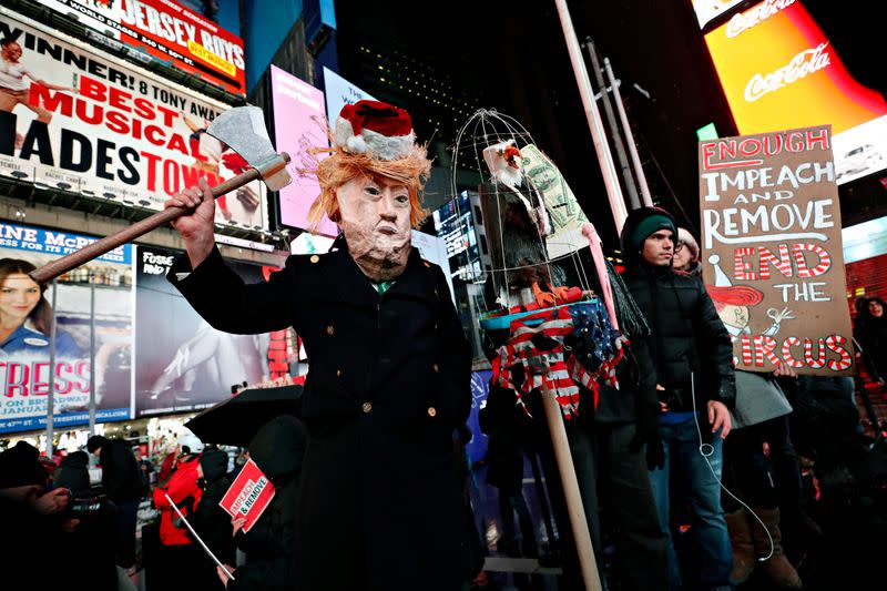 Demonstrators gather to demand the impeachment and removal of U.S. President Donald Trump during a rally at Times Square in New York City