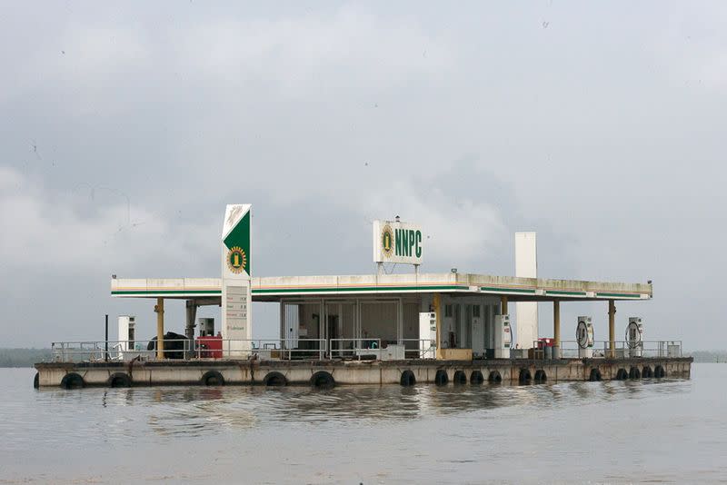 FILE PHOTO: A floating fuel filling station belonging to Nigeria’s state oil firm Nigerian National Petroleum Corporation sits idle on a river in the oil rich southeastern Delta state