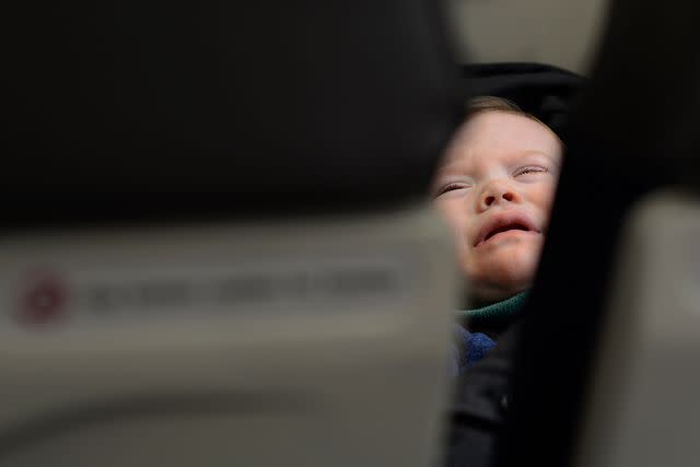 <p>Robert Alexander/Getty</p> A toddler cries on an airplane.