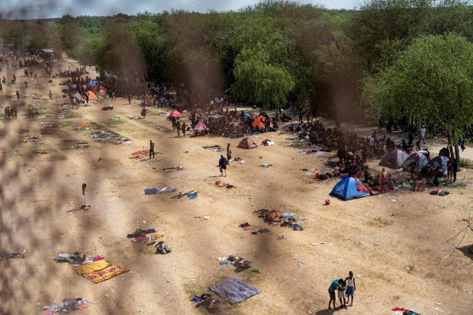 Migrants seeking asylum in the U.S. rest near the International Bridge between Mexico and the U.S. as they wait to be processed, in Del Rio, Texas