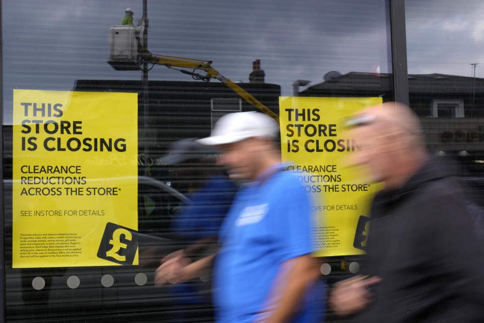 FILE - Pedestrians pass a closing down shop in London, on Sept. 23, 2022. The British government’s economic stimulus plan is designed to help people and businesses by cutting taxes and growing the economy. But it's had the opposite effect as the promise of huge unfunded tax cuts sparked turmoil in financial markets and sent the British pound tumbling to a record low against the U.S. dollar this week. (AP Photo/Kirsty Wigglesworth, File)