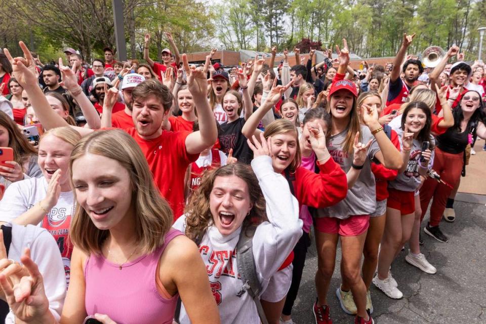 NC.State fans cheer as a bus carrying the men’s basketball team departs campus Wednesday, April 3, 2024. The team is headed to the Final Four for the first time since 1983. Travis Long/tlong@newsobserver.com