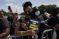 Audrey Dimartinez stands with her grand daughter Eliysia Leber as they listen to speakers during the March on Washington, Friday Aug. 28, 2020, in Washington, on the 57th anniversary of the Rev. Martin Luther King Jr.'s "I Have A Dream" speech. (AP Photo/Carolyn Kaster)