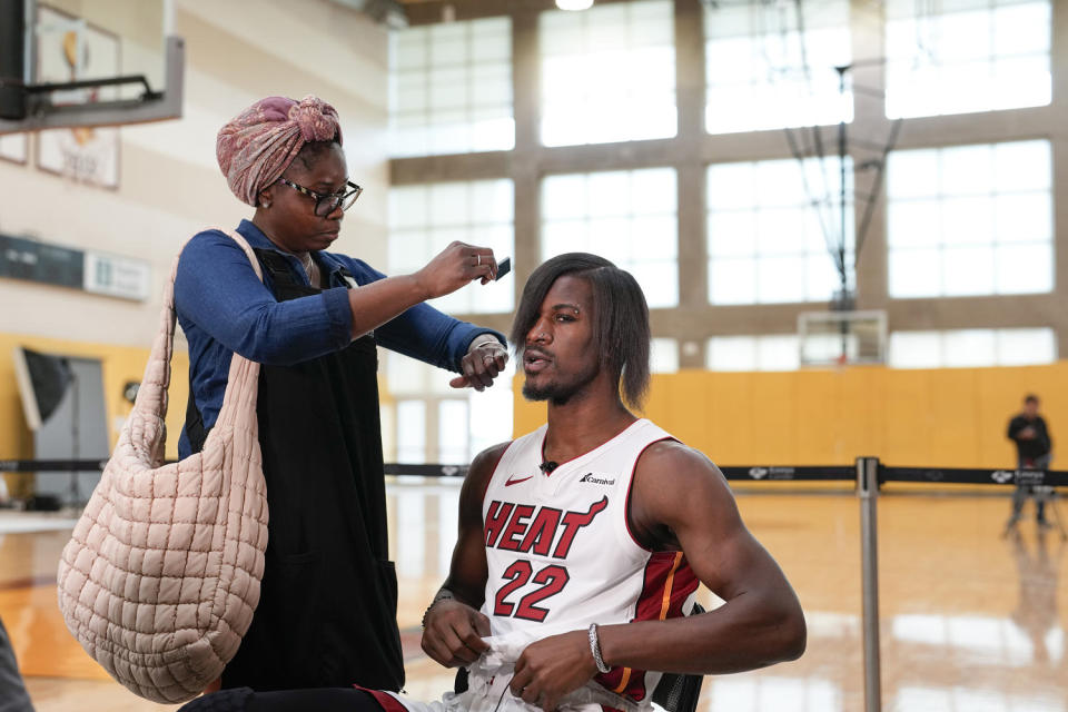 Miami Heat forward Jimmy Butler  gets his new hairdo brushed  (Rebecca Blackwell / AP)
