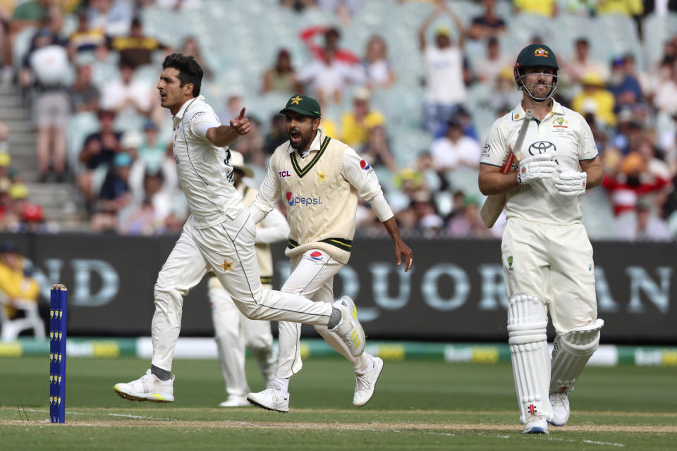 Pakistan's Mir Hamza, left, celebrates the wicket of Australia's Mitchell Marsh, right, for 96 runs during the third day of their cricket test match in Melbourne, Thursday, Dec. 28, 2023. (AP Photo/Asanka Brendon Ratnayake)