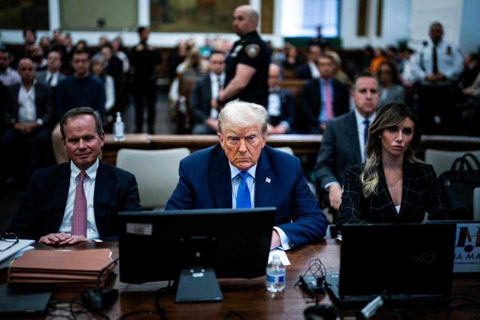 Donald Trump sits with his attorneys before his fraud trial testimony inside New York Supreme Court on 6 November (Getty Images)