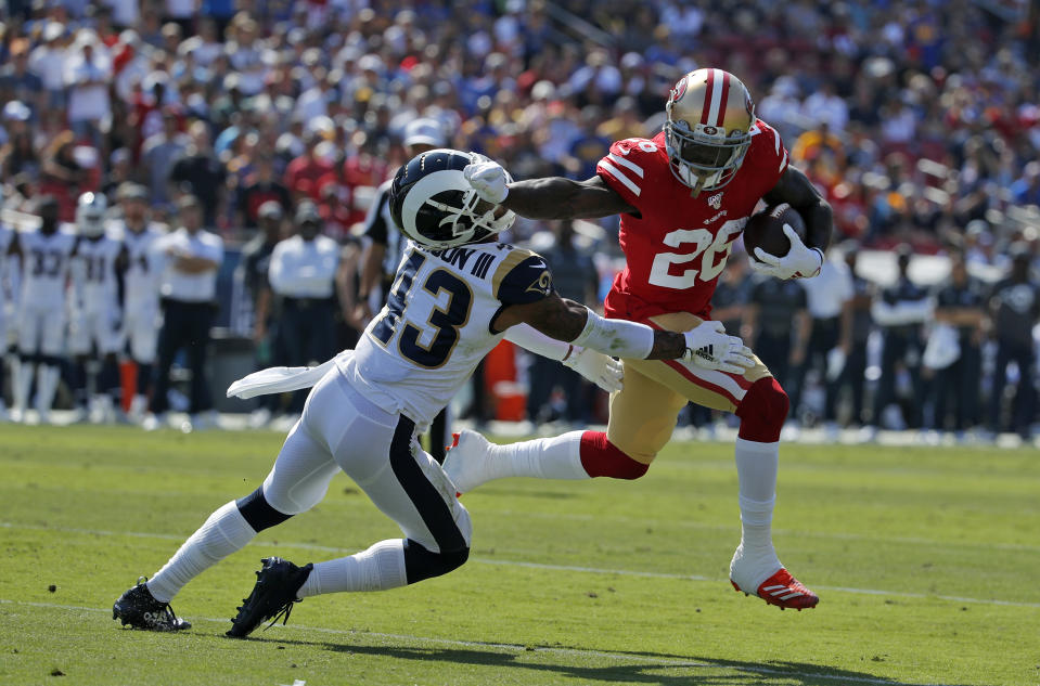 San Francisco 49ers running back Tevin Coleman (26) runs around Los Angeles Rams strong safety John Johnson (43) to score a touchdown during the first half of an NFL football game Sunday, Oct. 13, 2019, in Los Angeles. (AP Photo/John Locher )