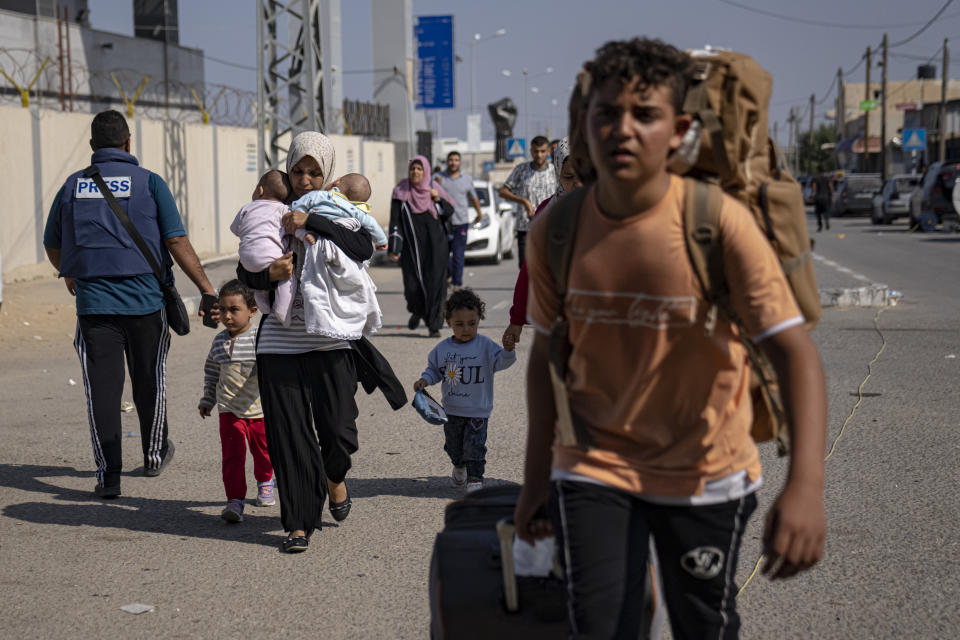 Palestinians arrive at Rafah, the border crossing between the Gaza Strip and Egypt, on Wednesday, Nov. 1, 2023. (AP Photo/Fatima Shbair)