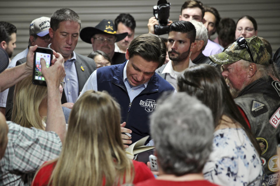 Florida Gov. Ron DeSantis signs an autograph after giving a speech at a rally in Council Bluffs, Iowa, Wednesday. Several hundred people filled half of an event center to listen to DeSantis speak in his first trip to Iowa since announcing his presidential campaign. (AP Photo/Josh Funk)