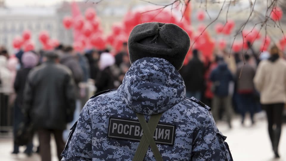 A Rosgvardia serviceman watches a parade in Russia. The force, which reports directly to Russian President Vladimir Putin, has been deployed to occupied Ukraine to quash protests and opposition. - Aleksey Smagin/Sipa USA/AP