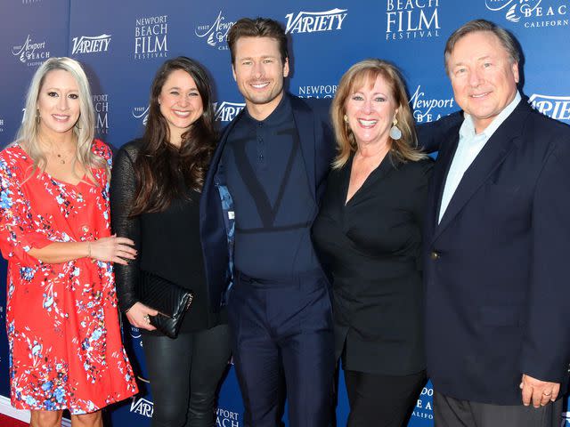 <p>Nicky Nelson/WENN.com/Alamy</p> Glen Powell and his family at a red carpet event in November 2019