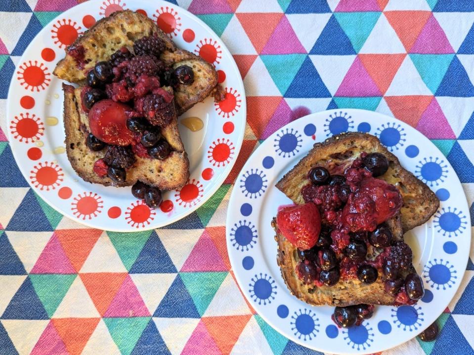 two plates with air-fried french toast and berries