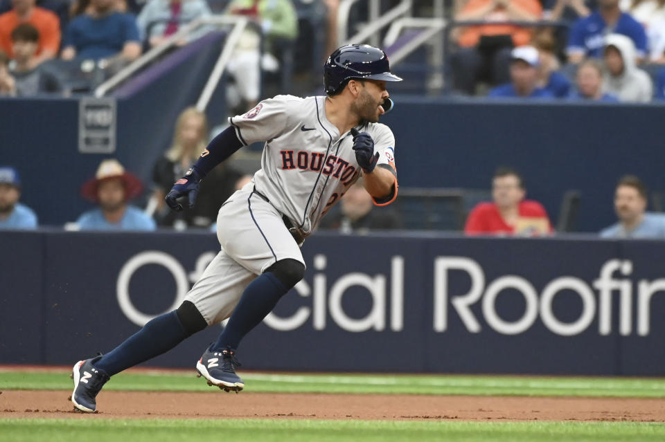 Houston Astros' Jose Altuve (27) runs back to first base after hitting a single against the Toronto Blue Jays during the first inning of a baseball game, Tuesday, July 2, 2024, in Toronto. (Jon Blacker/The Canadian Press via AP)