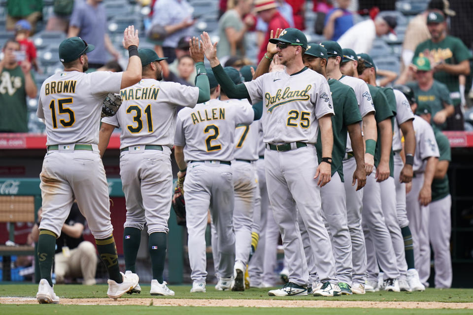 Oakland Athletics players celebrate the team's 8-7 win in a baseball game against the Los Angeles Angels Thursday, Aug. 4, 2022, in Anaheim, Calif. (AP Photo/Jae C. Hong)