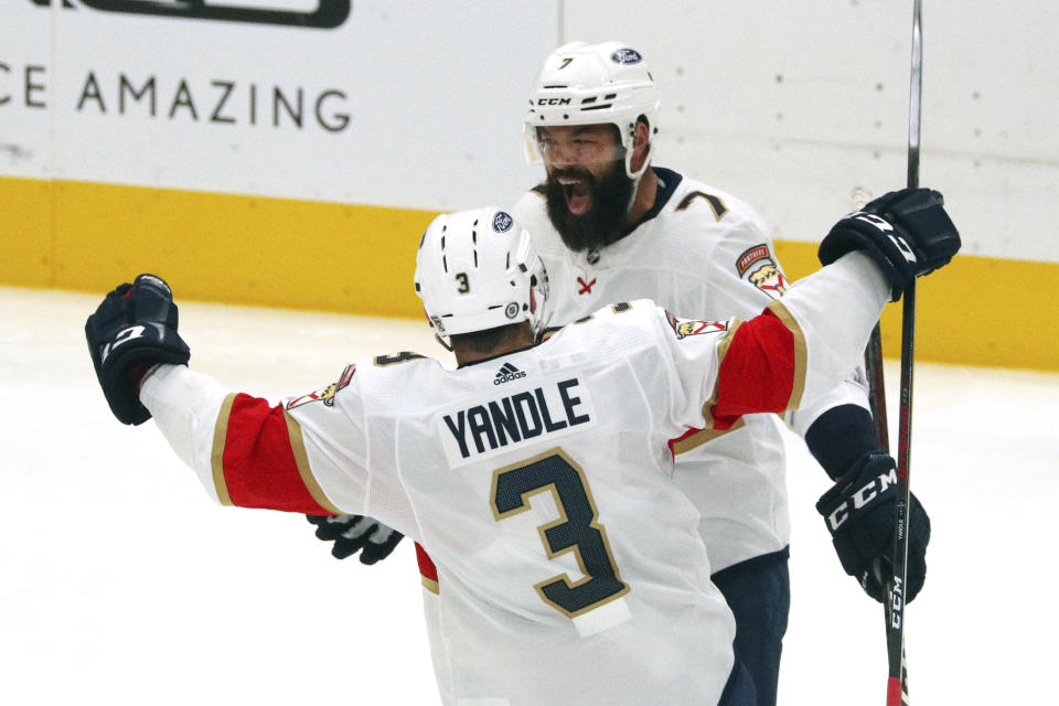 Florida Panthers defenseman Keith Yandle (3) celebrates a goal by defenseman Radko Gudas (7) against the Dallas Stars during the second period of an NHL hockey game Tuesday, April 13, 2021, in Dallas. (AP Photo/Richard W. Rodriguez)