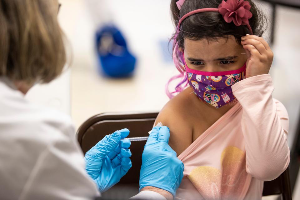 Suelhen Nunez Lopez, 7, grimaces as receives a COVID-19 vaccine as residents brought youth to be vaccinated at Carter Traditional Elementary School in Kentucky at a vaccine drive on Nov. 13, 2021.