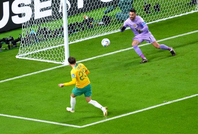 Australia's Craig Goodwin, left, scores against France