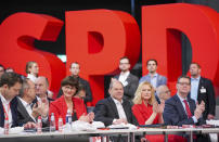 Party secretary Lars Klingbeil, Norbert Walter-Borjans, Saskia Esken, Federal Finance Minister Olaf Scholz, Manuela Schwesig and Thorsten Schaefer-Guembel, from left, during the German Social Democrats, SPD, federal party conference in Berlin, Germany, Friday, Dec. 6, 2019. Members of the center-left party have choosen the left-leaning duo Norbert Walter-Borjans and Saskia Esken as their new leaders. This has to be confirmed by the delegates at the party meeting. (Kay Nietfeld/dpa via AP)