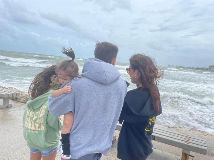 The Otto family of Fort Pierce went to the Fort Pierce jetty Wednesday Sept. 28, 2002 to see the storm surge as wind tore through the area.  Pictured are Dustin Otto, his wife Cindy Maynetto, and daughters Aaliyah and baby Olivia