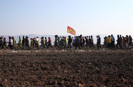 African migrant laborers stage a march to protest against their work conditions in Italy, following the death of 16 of their colleagues in two separate road accidents, near Foggia, Italy August 8, 2018. REUTERS/Alessandro Bianchi