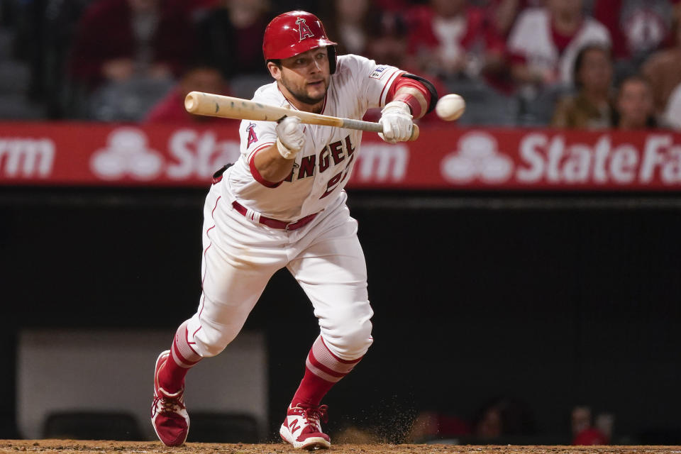 FILE - Los Angeles Angels' David Fletcher hits a bunt single against the Oakland Athletics during the third inning of a baseball game Sept. 29, 2023, in Anaheim, Calif. The Angels traded Fletcher and Max Stassi to teh Atlanta Braves on Friday, Dec. 8, for Evan White and Tyler Thomas. (AP Photo/Ryan Sun, File)