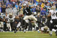 Dec 22, 2013; Charlotte, NC, USA; Carolina Panthers quarterback Cam Newton (1) runs as New Orleans Saints middle linebacker Curtis Lofton (50) and outside linebacker David Hawthorne (57) and cornerback Corey White (24) defend in the third quarter at Bank of America Stadium. Mandatory Credit: Bob Donnan-USA TODAY Sports