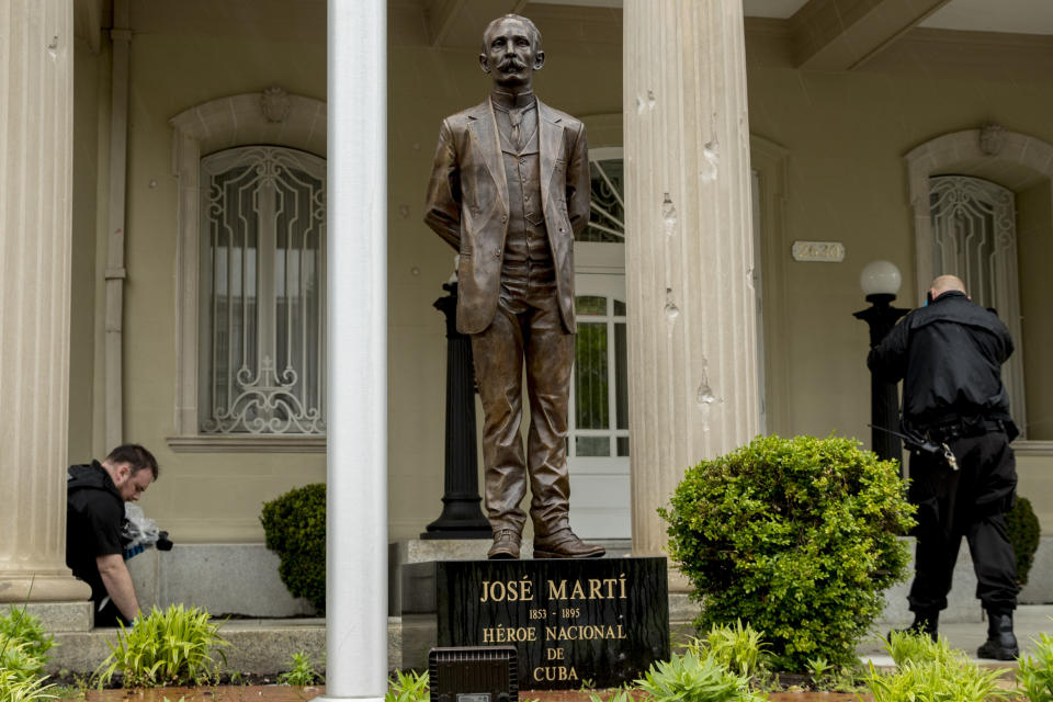 Bullet holes are visible on a column behind a statue of Cuban independence hero José Martí as Secret Service officers investigate after police say a person with an assault rifle opened fire at the Cuban Embassy, Thursday, April 30, 2020, in Washington. Officers found the suspect with an assault rifle and took the person into custody without incident, police said. (AP Photo/Andrew Harnik)