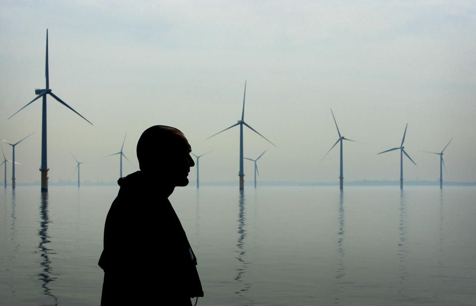 A maintenance worker looks out over the turbines of the Burbo Bank off shore wind farm in the mouth of the River Mersey in Liverpool (Christopher Furlong/Getty Images)