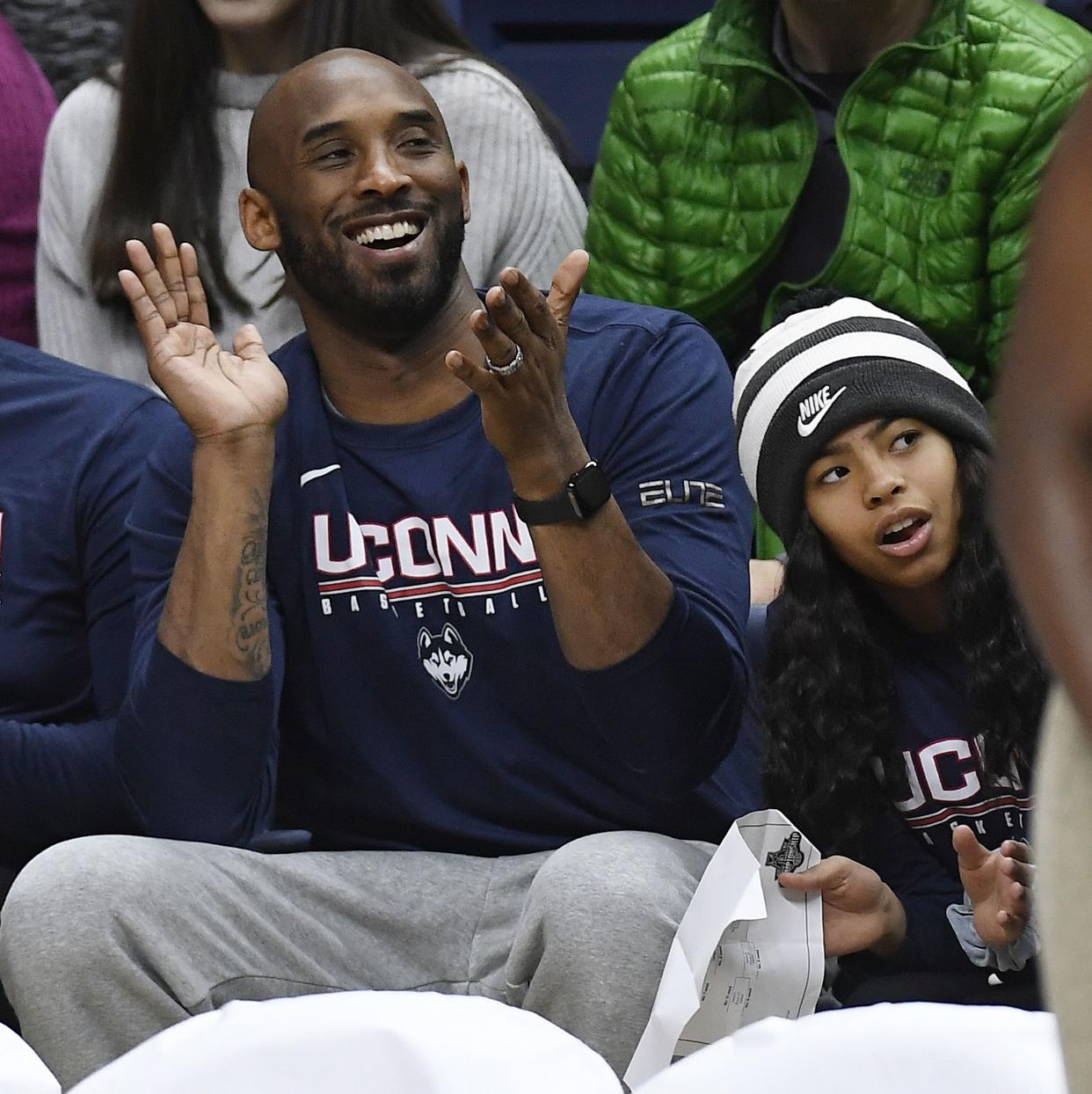 Kobe Bryant and his daughter Gianna watch the first half of an NCAA college basketball game between Connecticut and Houston, Saturday, March 2, 2019, in Storrs, Conn.