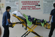 Medical workers deliver a patient with COVID-19 to the Emergency Room at Star County Memorial Hospital, Monday, July 27, 2020, in Rio Grande City, Texas. (AP Photo/Eric Gay)