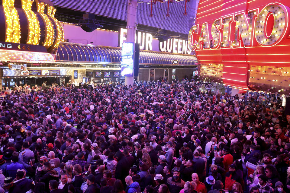 Revelers celebrate on New Year's Eve at the Fremont Street Experience in downtown Las Vegas Friday, Dec. 31, 2021. (K.M. Cannon/Las Vegas Review-Journal via AP)