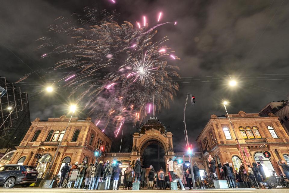 Fireworks are released for the new Danish King Frederik X over the historic amusement park Tivoli in Copenhagen, Denmark, Sunday, Jan. 14, 2024. Denmark's new King took over the crown on Sunday from his mother, Queen Margrethe II, who was breaking with centuries of Danish royal tradition and retired after a 52-year reign. (AP Photo/Martin Meissner)