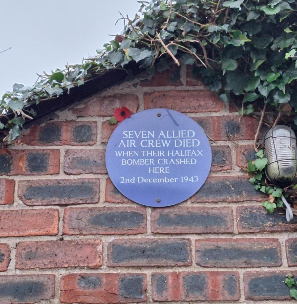 Darlington and Stockton Times: A blue plaque marking the spot where seven Allied air crew lost their lives in Northallerton when a Halifax bomber crashed on December 2, 1943