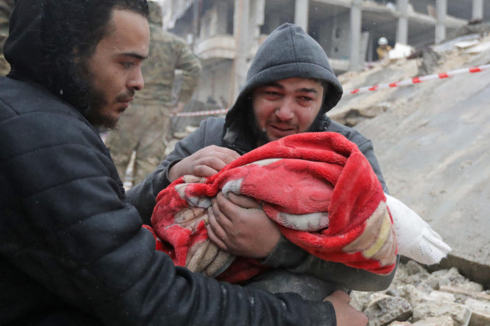 A man carries the body of his son in Jandaris in the rebel-held area of Syria's Aleppo province. (Bakr Alkasem / AFP - Getty Images)