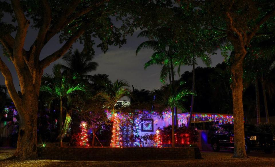 Carol and Eric Froberg decorate their North Miami house, 1840 Keystone Blvd., with Christmas trees of different sizes, a laser show and glittering icicles.
