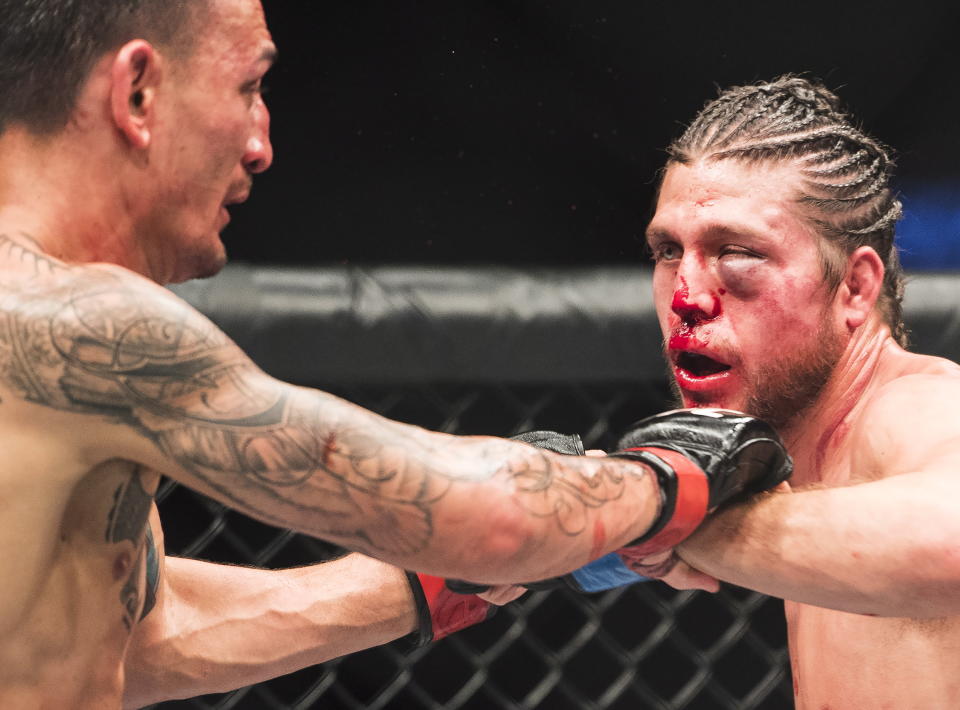 Max Holloway, left, fights Brian Ortega during the featherweight championship mixed martial arts bout at UFC 231 in Toronto on Saturday, Dec. 8, 2018. (Nathan Denette/The Canadian Press via AP)