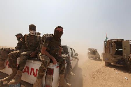 Kurdish Peshmerga forces ride on military vehicles on the southeast of Mosul, Iraq, August 14, 2016. REUTERS/Azad Lashkari