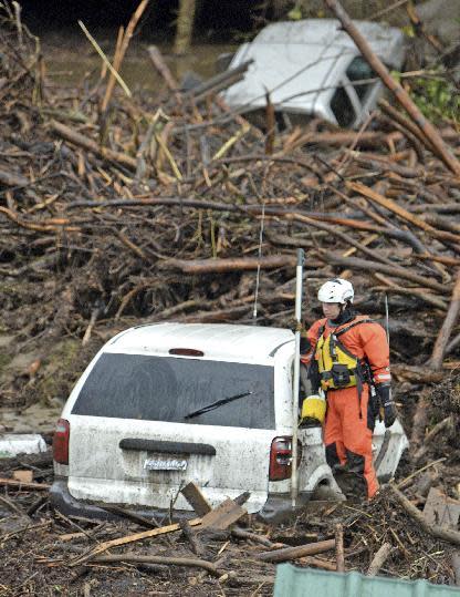 Rescue crews search for victims Friday, Jan. 20, 2017 at the El Capitan Canyon campground following flooding due to heavy rains in Gaviota, Calif. Dozens of campers were rescued and evacuated following the morning flood that swept large wooden cabins and vehicles away. (Mike Eliason/Santa Barbara County Fire Department via AP)