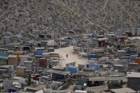 A person walks through the Virgin of Lourdes Cemetery in Lima, Peru, Friday, Dec. 9, 2022. (AP Photo/Fernando Vergara)