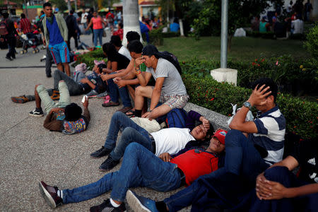 Central Americans, part of a caravan trying to reach the U.S., rest before joining others to try to cross to Mexico and carry on their journey, in Tecun Uman, Guatemala, October 28, 2018. REUTERS/Carlos Garcia Rawlins