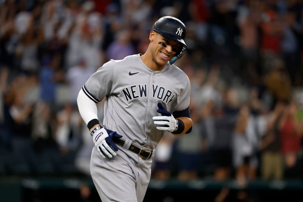 Aaron Judge #99 of the New York Yankees smiles as he rounds the bases after hitting his 62nd home run of the season against the Texas Rangers during the first inning in game two of a double header at Globe Life Field on October 4, 2022 in Arlington, Texas