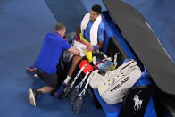 Novak Djokovic of Serbia receives treatment to a leg injury during his third round match against Grigor Dimitrov of Bulgaria at the Australian Open tennis championship in Melbourne, Australia, Saturday, Jan. 21, 2023. (AP Photo/Dita Alangkara)