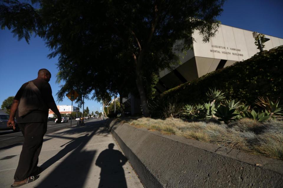 A man walks by the Augustus F. Hawkins Mental Health Center in Willowbrook.