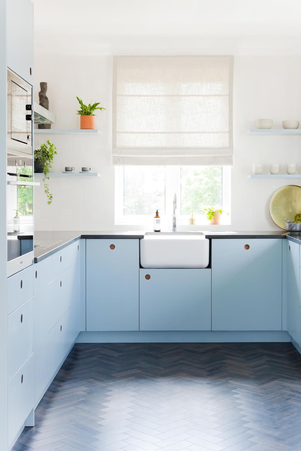 small blue kitchen with cabinets