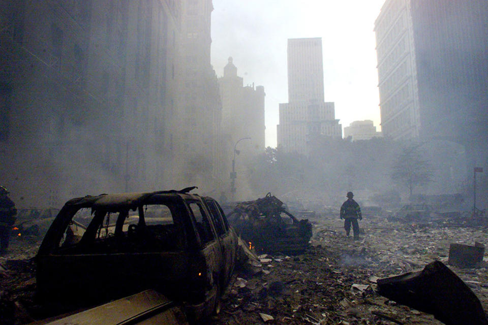 <p>A firefighter walks amid rubble near the base of the destroyed World Trade Center in New York on Sept. 11, 2001. (Photo: Peter Morgan/Reuters) </p>