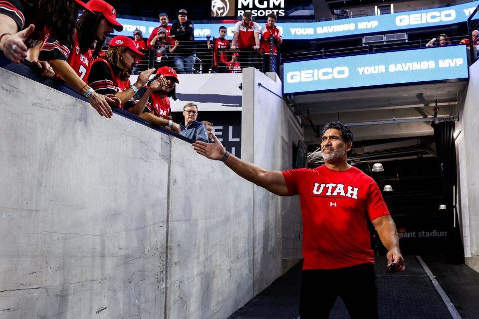 Utah defensive line coach Luther Elliss high-fives a fan before Pac-12 championship game against USC at Allegiant Stadium in Las Vegas, on Friday, Dec. 2, 2022. | Hunter Dyke, Utah Athletics
