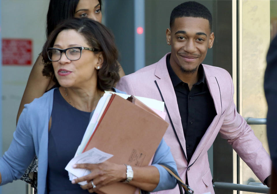 Rapper Lil Za, right, leaves Los Angeles Superior Court with his attorney, Shawn Holley, after his arraignment on Wednesday, April 30, 2014. Lil Za, who's real name Xavier Smith, pleaded no contest to felony possession of ecstasy, and was sentenced to three years of probation and a drug treatment program in a case that was filed after he was arrested during a search of Justin Bieber’s mansion in January 2014. (AP Photo/Nick Ut)