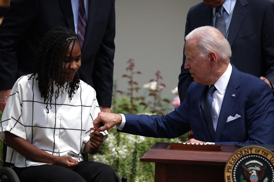 President Joe Biden gives a pen to artist Tyree Brown after signing a proclamation on the anniversary of the Americans with Disabilities Act on July 26, 2021 in Washington, DC.